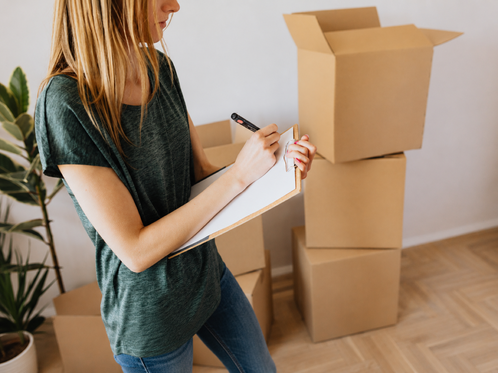 Small retailer checking cartons and inventory notes for cash flow pressure